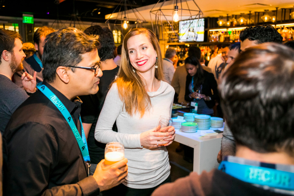 Recur attendees at the bar, smiling